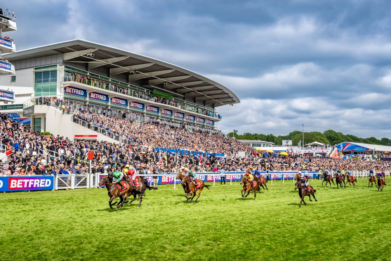 Sea Scout, ridden by jockey Harry Davies, crosses the finish line narrowly ahead of Trinity College during the 2025 Blue Riband Trial at Epsom Downs.
