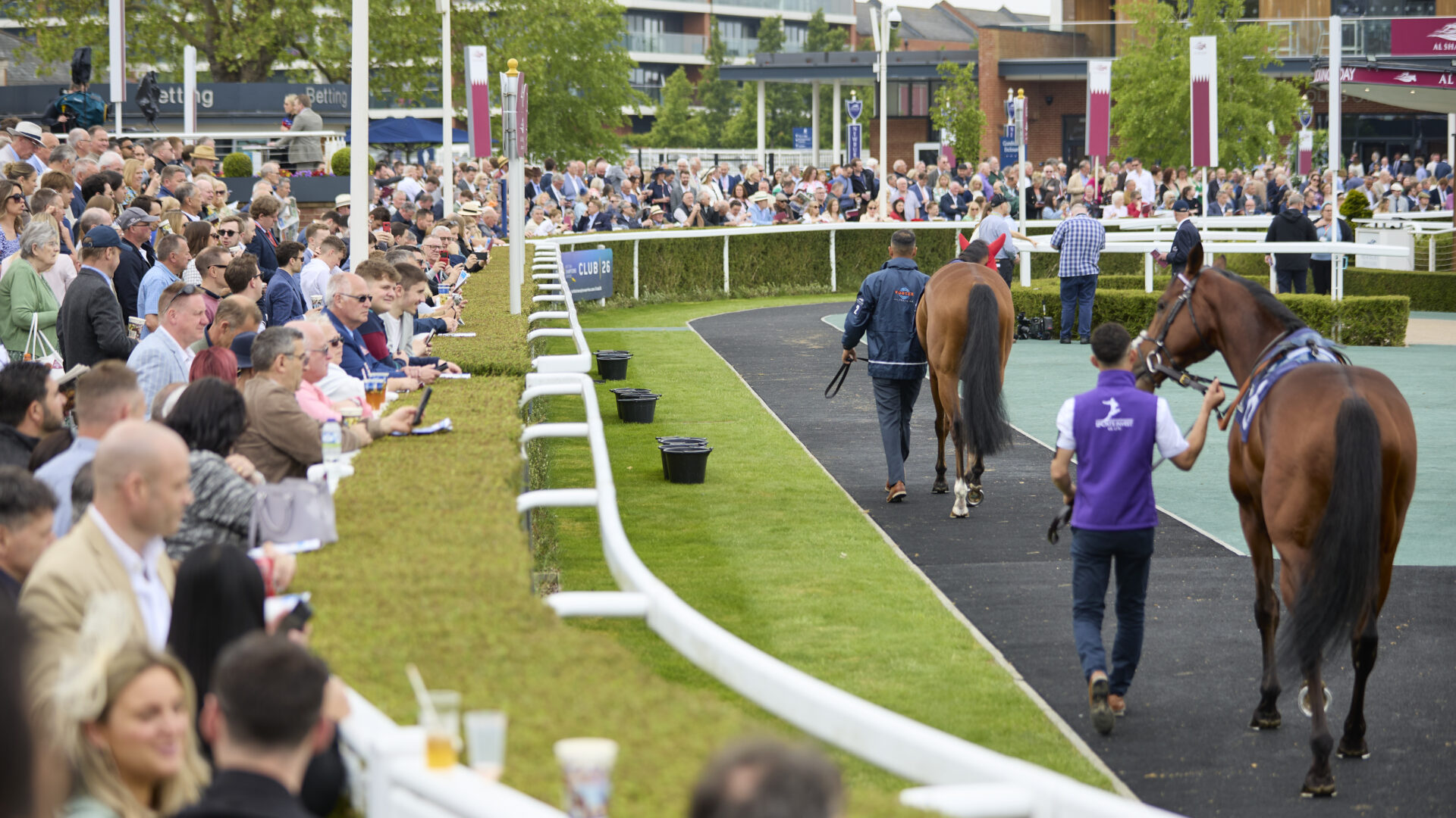 Newbury Racecourse's main grandstand and parade ring captured, illustrating the venue's scale and design.