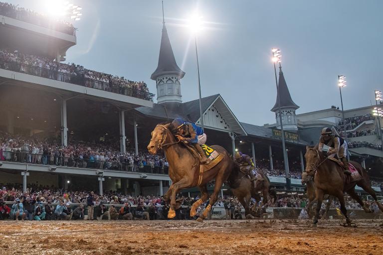 SOVEREIGNTY in full flight under the iconic twin spires of Churchill Downs during his historic Derby win