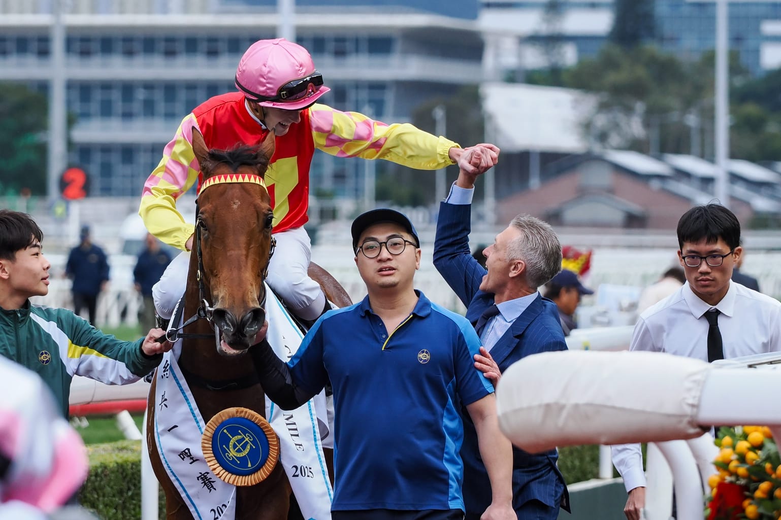Trainer Mark Newnham walking alongside his horse My Wish at Sha Tin Racecourse after a strong performance in a Group 1 race.