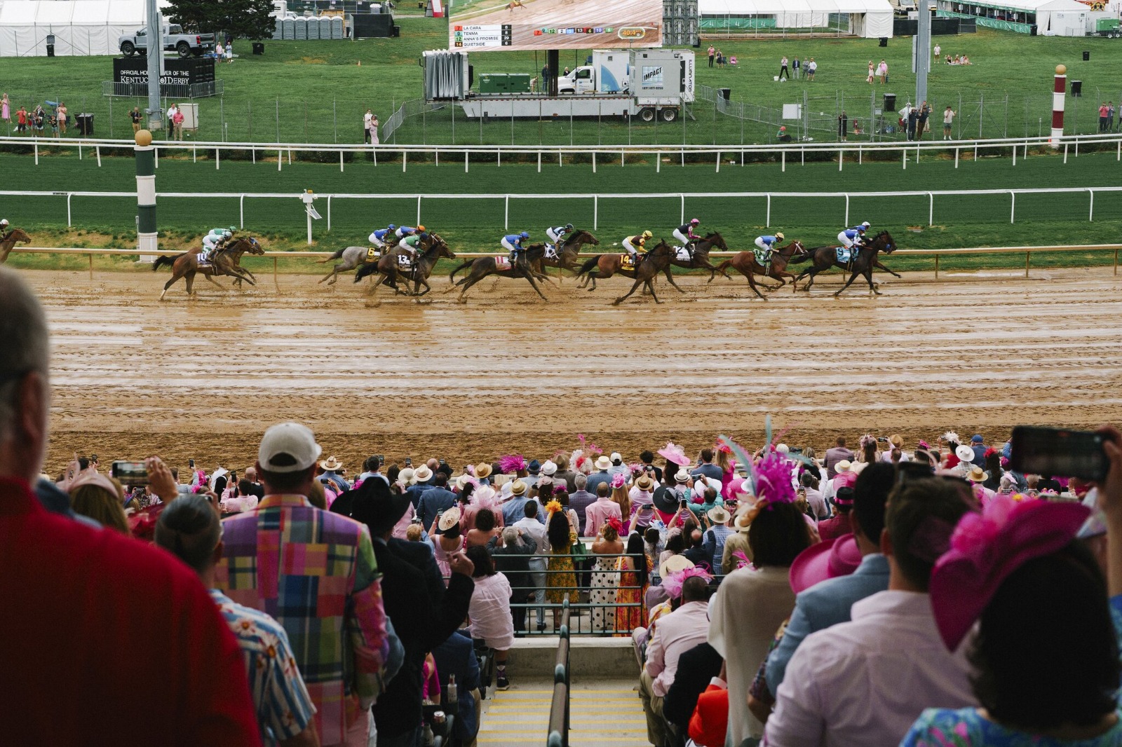 GOOD CHEER, the winning filly of the 2025 Kentucky Oaks, crosses the finish line on a muddy track at Churchill Downs, with jockey Luis Saez aboard.
