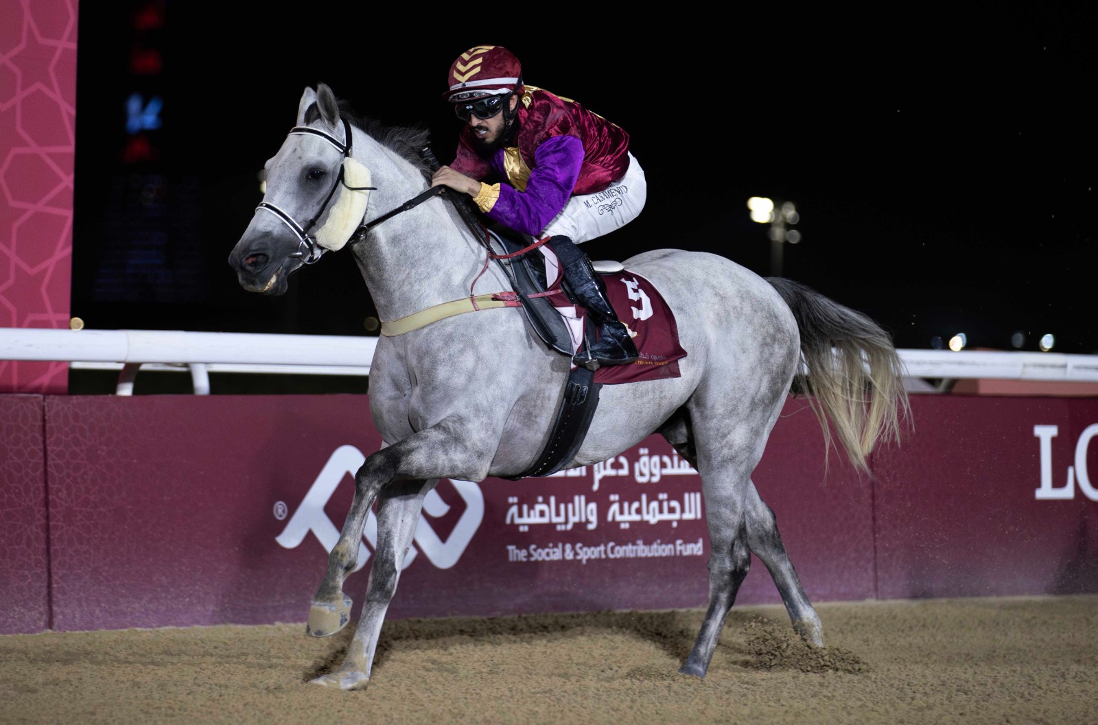 Jockeys and horses competing on the dirt track at Al Rayyan Racecourse during the Qatar Racing and Equestrian Club’s race day on May 8, 2025.