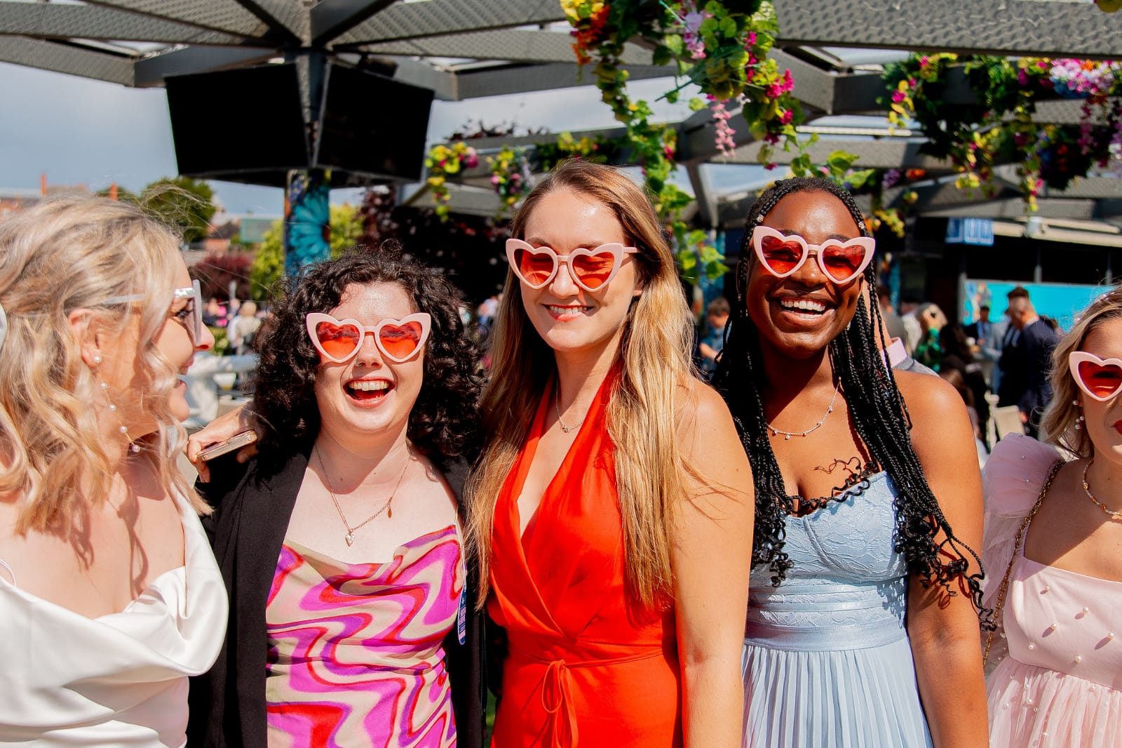 Stylishly dressed women attending a past Ladies Day at Chester Racecourse, showcasing elegant fashion and race day glamour.