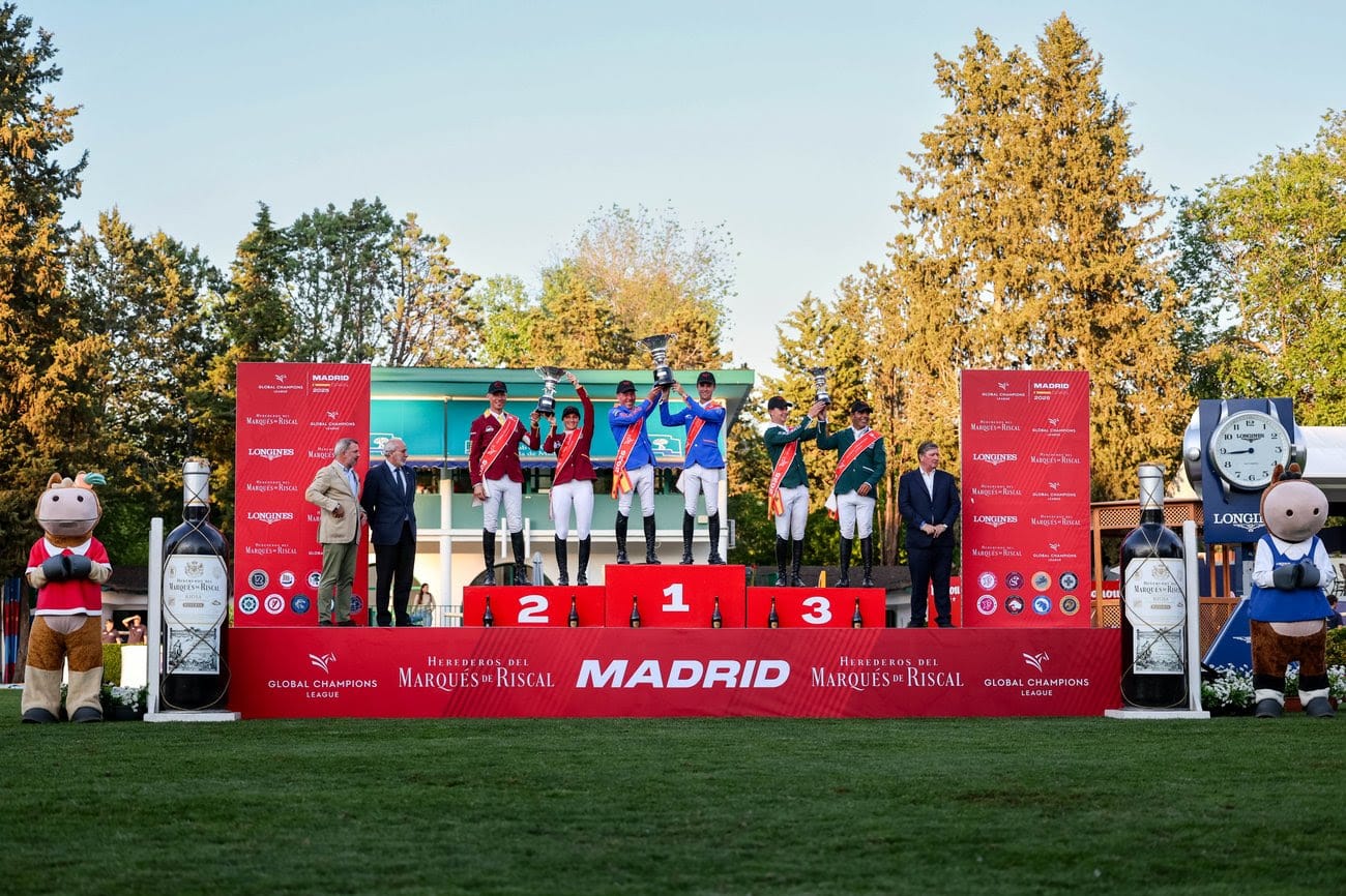 Valkenswaard United riders celebrating their 2025 GCL Madrid victory with spectators in the background at Club de Campo Villa de Madrid.