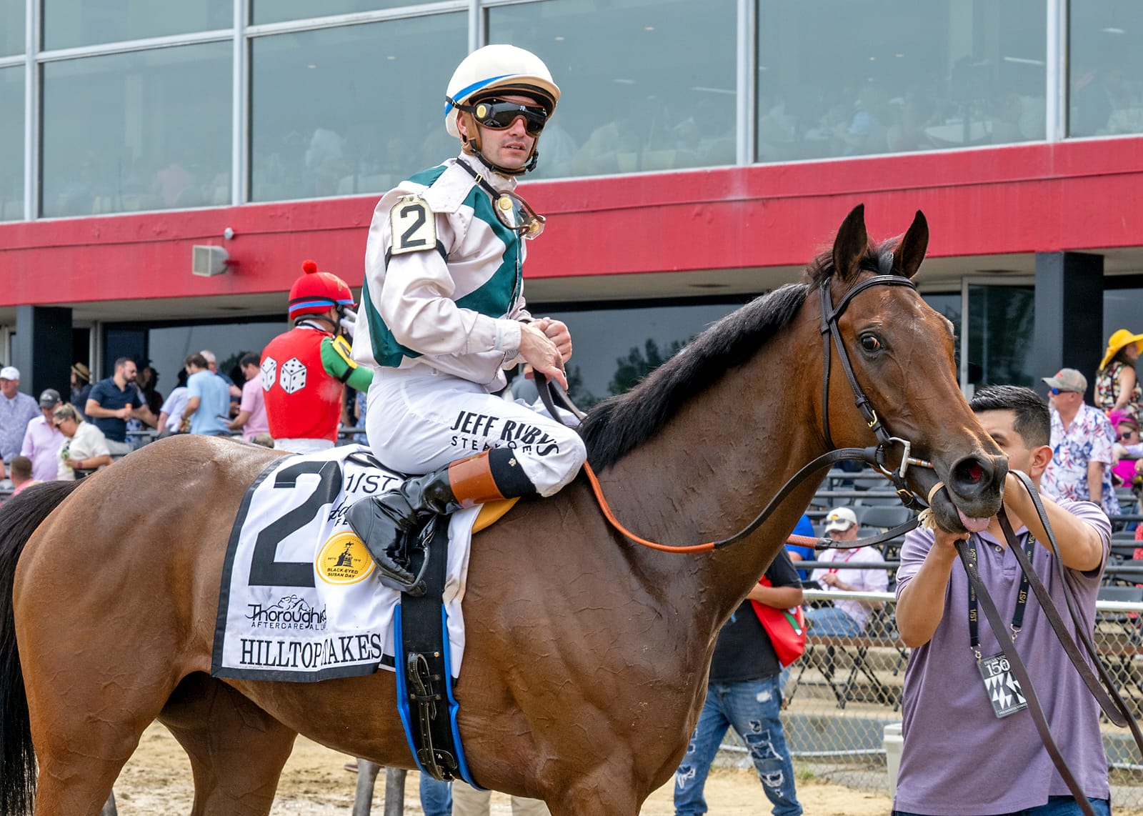 Play With Fire charging past rivals down the Pimlico turf stretch under jockey Flavien Prat to win the 2025 Hilltop Stakes