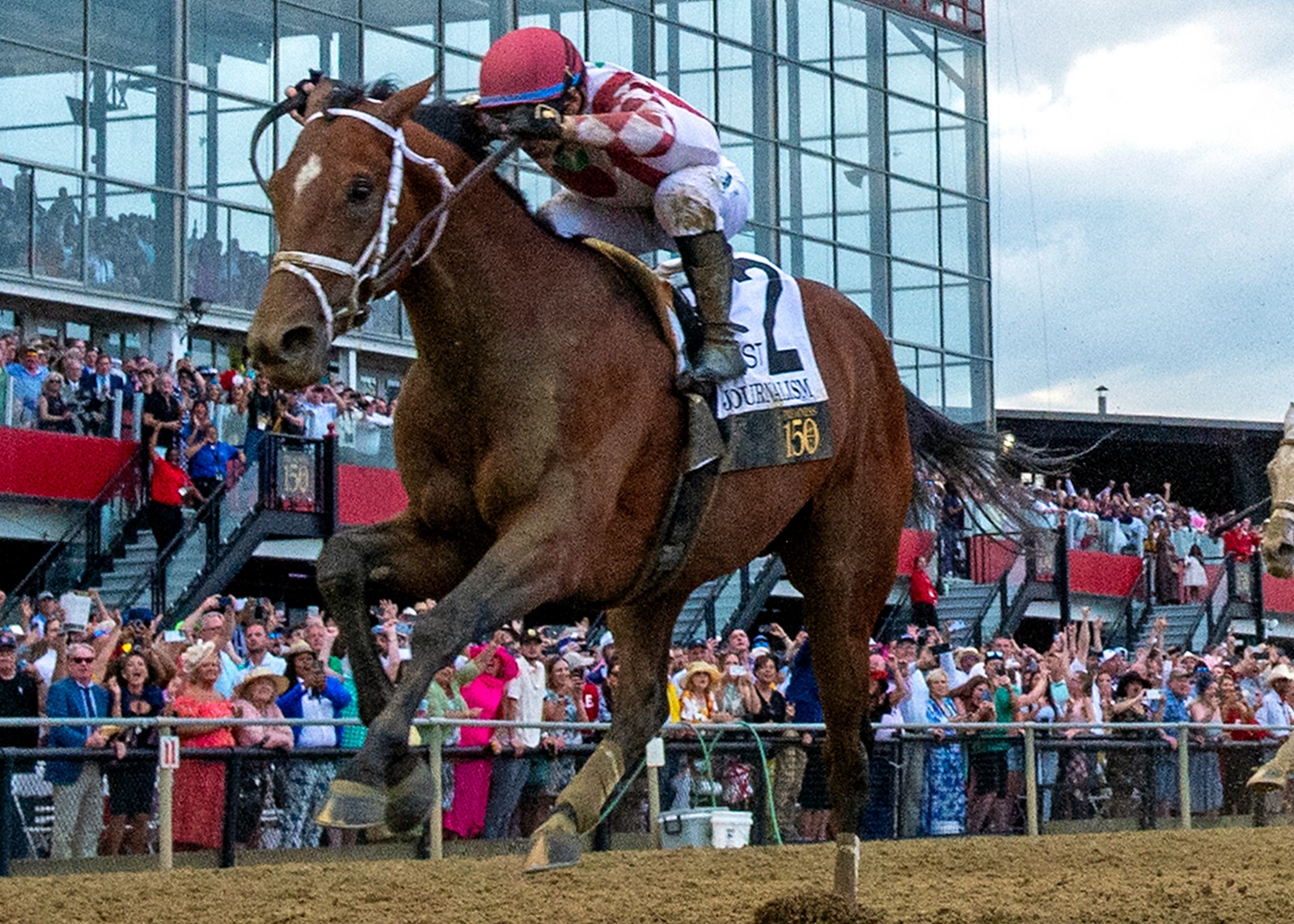 Journalism surging to victory in the Preakness Stakes at Pimlico Race Course under jockey Umberto Rispoli