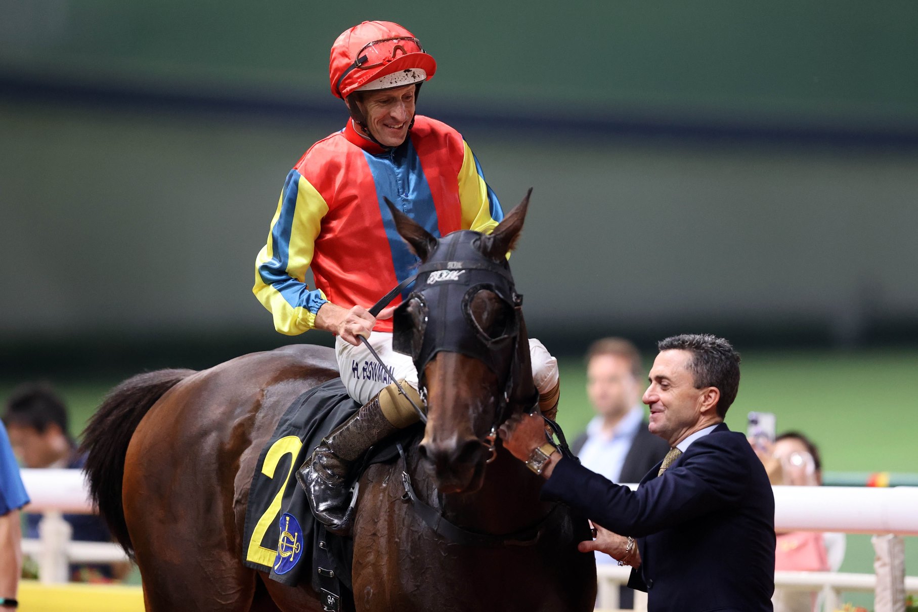 Jockey Hugh Bowman celebrates after riding a Douglas Whyte-trained horse to victory at Happy Valley, reaching 60 seasonal wins in Hong Kong