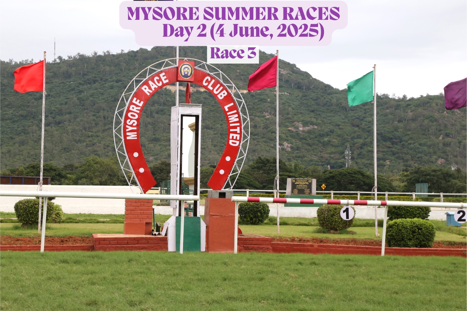 View of Mysore Race Club premises during the Mysore Summer Races Day 2 on June 4, 2025, featuring Race 3 signage, a large video screen displaying live race footage, and the SPARK branding in front of the heritage building.