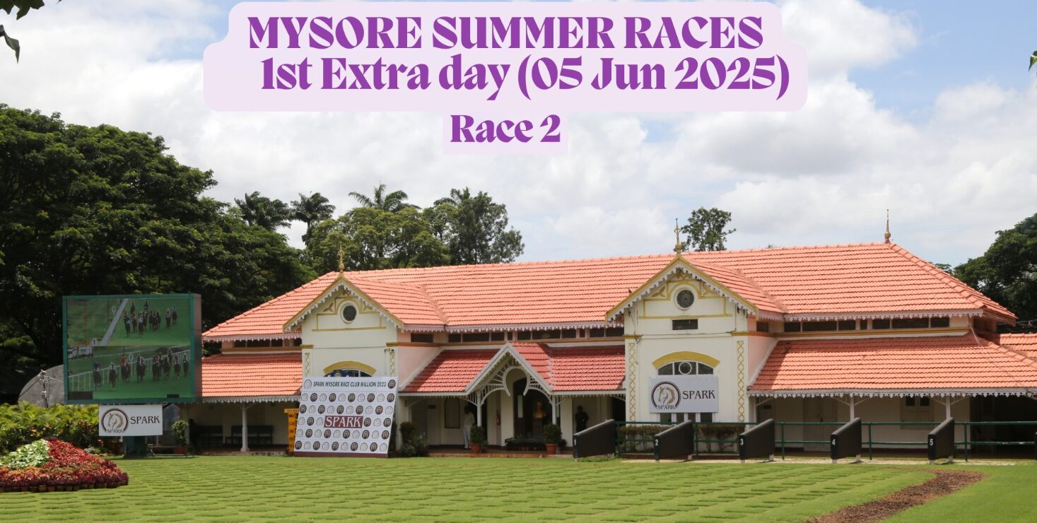 Mysore Race Club paddock area during the Mysore Summer Races 2025 extra race day on June 5, showing the main building, sponsor banners, and a large screen with race footage, set against a clear sky and lush greenery.