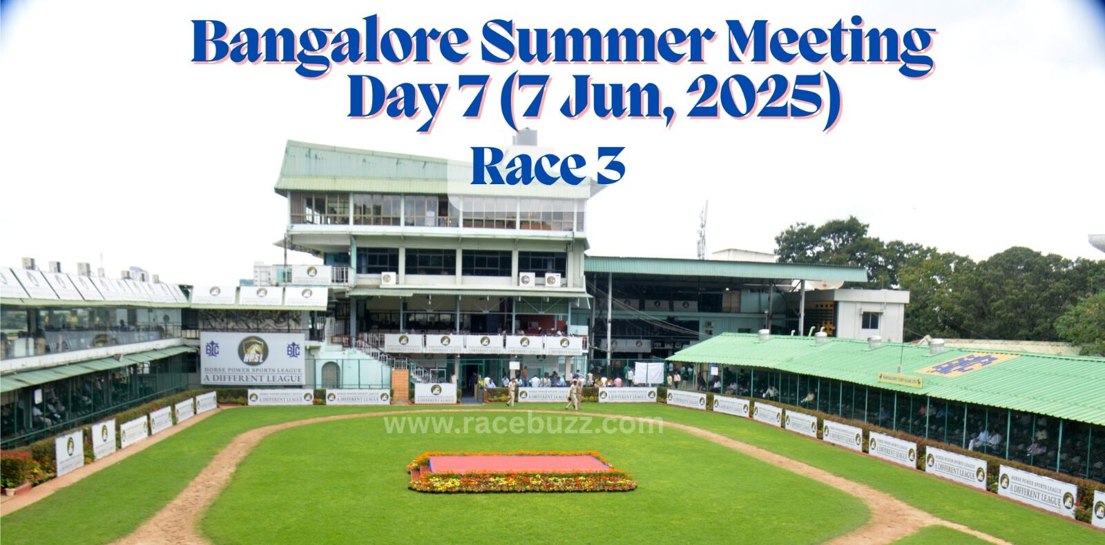 View of the paddock area at Bangalore Turf Club during the Bangalore Summer Meeting, Day 7 (7 June 2025), Race 3. The image shows the green walking ring, flower bed in the center, and surrounding grandstands with Horse Power Sports League branding.