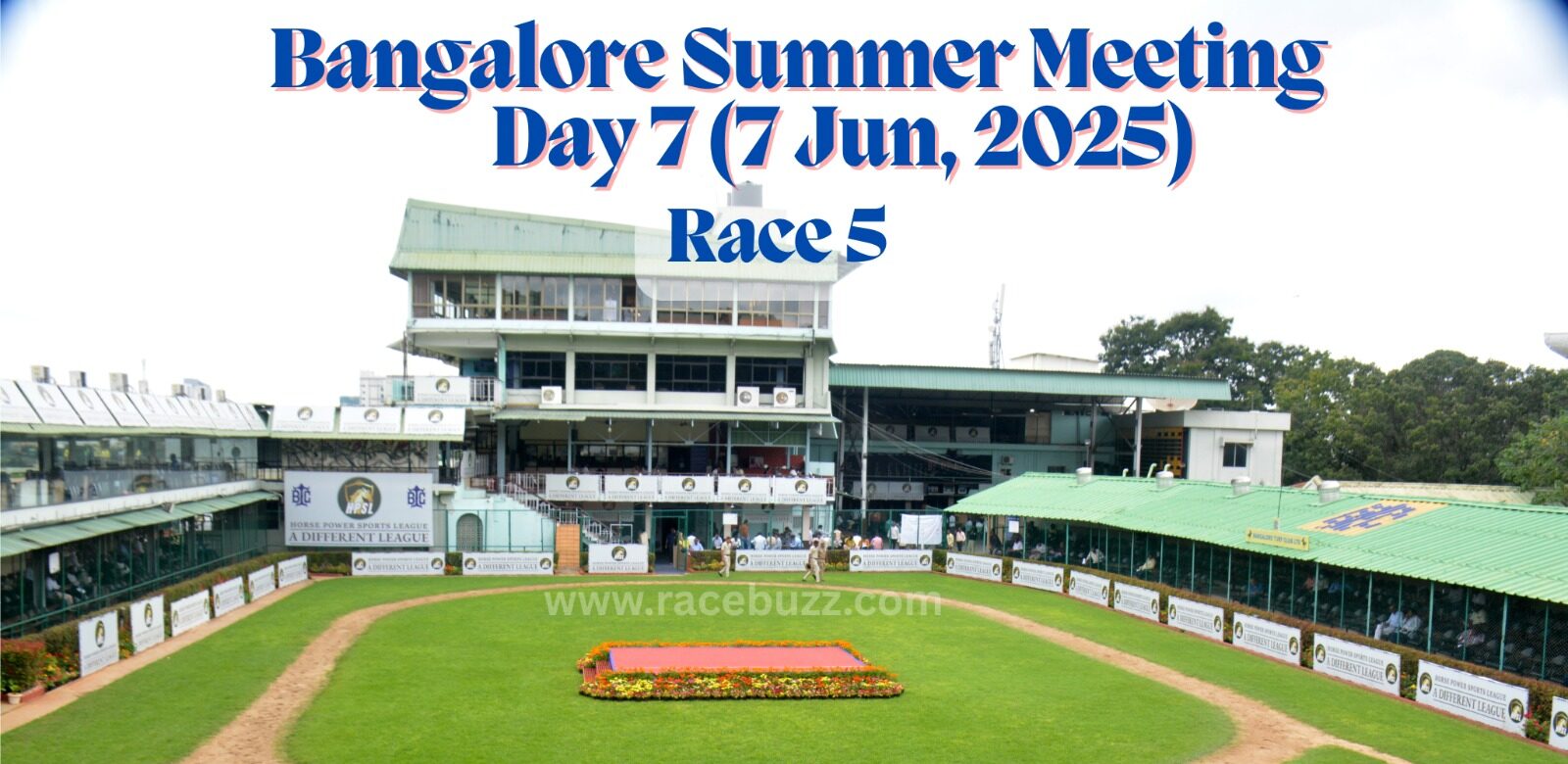 View of the paddock area at Bangalore Turf Club during the Bangalore Summer Meeting, Day 7 (7 June 2025), Race 5. The image shows the green walking ring, flower bed in the center, and surrounding grandstands with Horse Power Sports League branding.