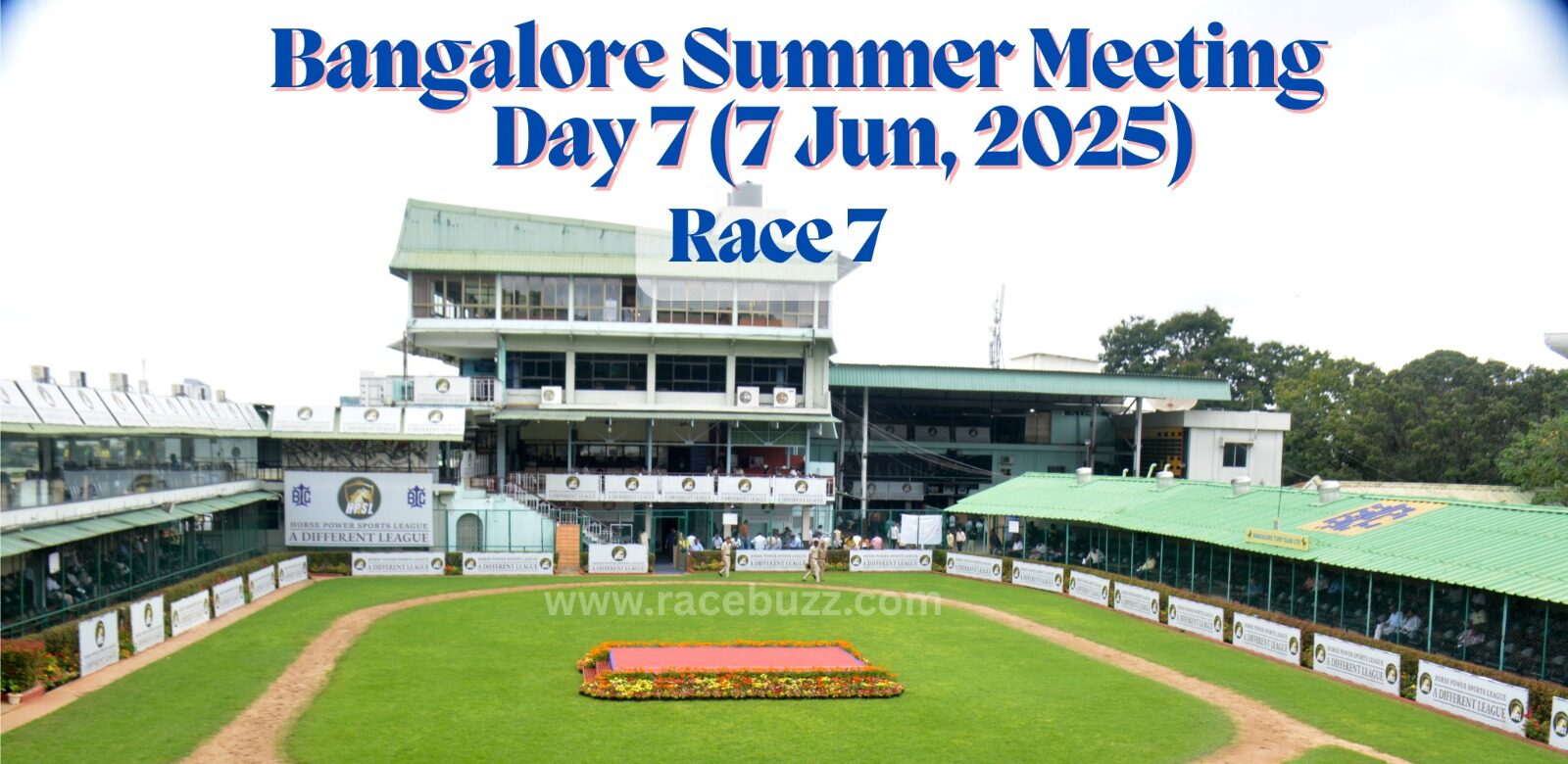 View of the paddock area at Bangalore Turf Club during the Bangalore Summer Meeting, Day 7 (7 June 2025), Race 7. The image shows the green walking ring, flower bed in the center, and surrounding grandstands with Horse Power Sports League branding.