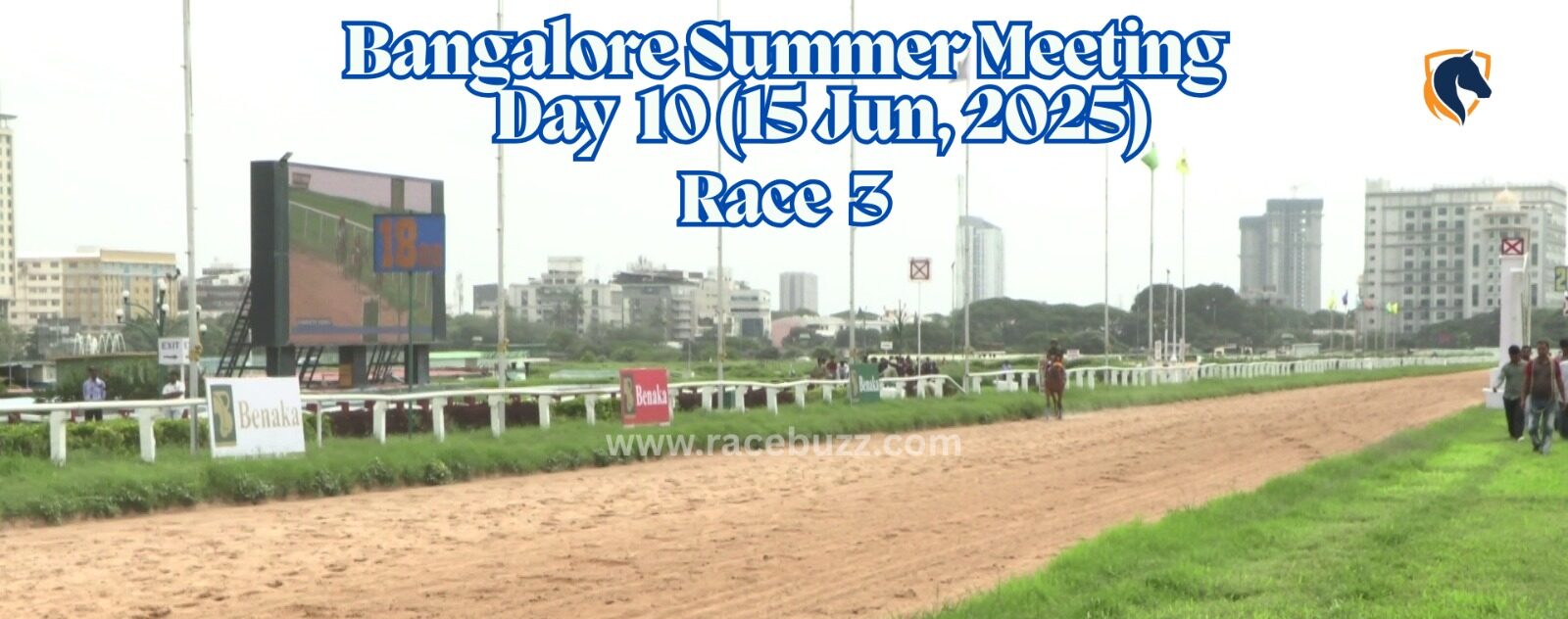View of the finishing stretch at Bangalore Turf Club during Race 3 on Day 10 of the Bangalore Summer Meeting, June 15, 2025, with the large screen showing race footage and race branding visible trackside.