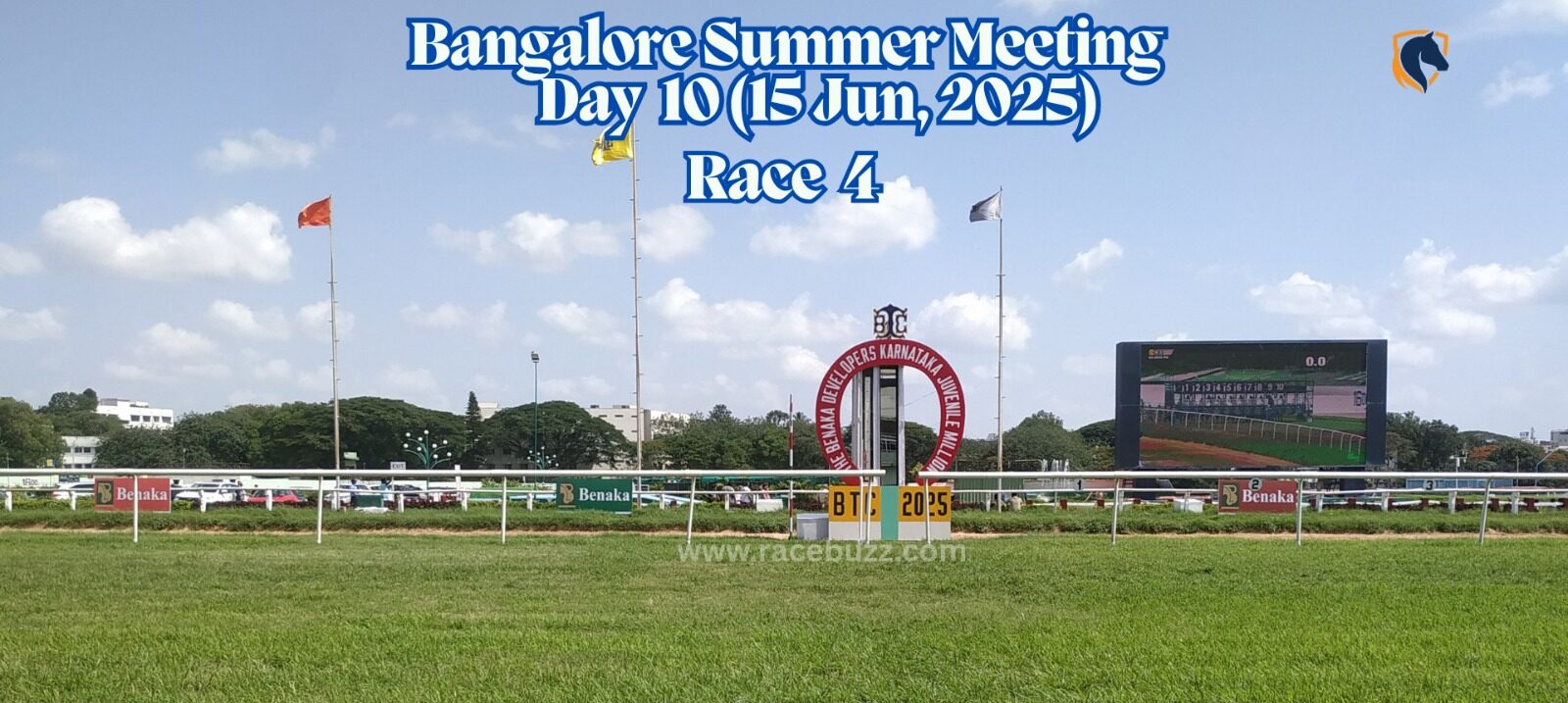 View of the finishing stretch at Bangalore Turf Club during Race 4 on Day 10 of the Bangalore Summer Meeting, June 15, 2025, with the large screen showing race footage and race branding visible trackside.