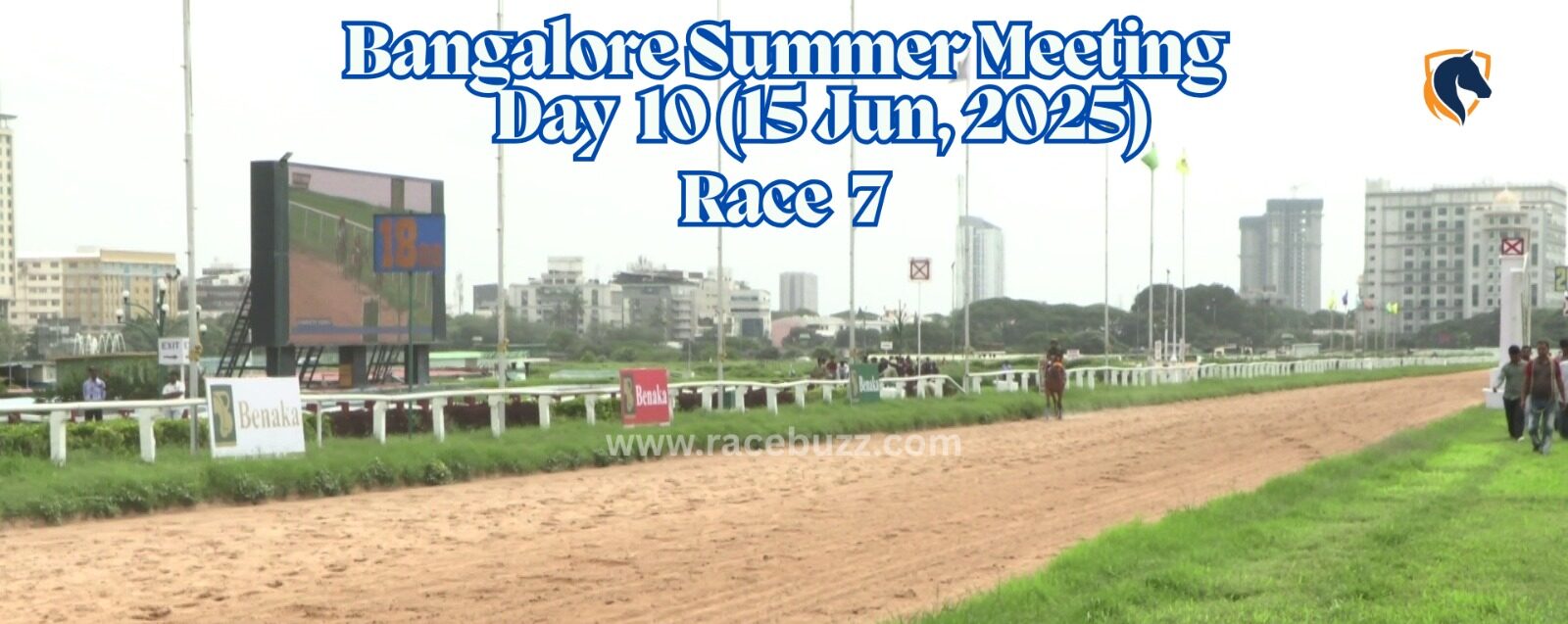 View of the finishing stretch at Bangalore Turf Club during Race 7 on Day 10 of the Bangalore Summer Meeting, June 15, 2025, with the large screen showing race footage and race branding visible trackside.