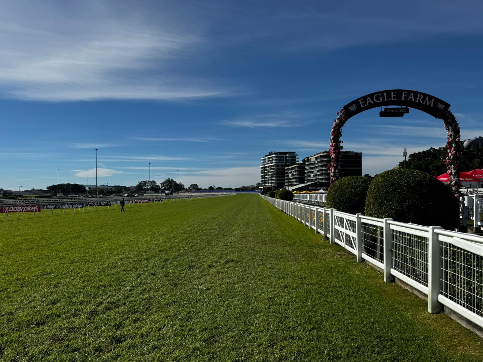 Aerial view of Doomben Racecourse set for the Brisbane Racing Club Wednesday Raceday with horses and crowd in the background