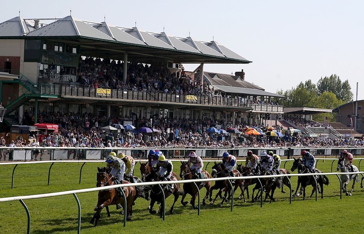 Racegoers gathered at Warwick Racecourse during sunset for Wigley Property Night on June 4, 2025, with horses and jockeys preparing at the starting line for the season's final evening of live racing action.