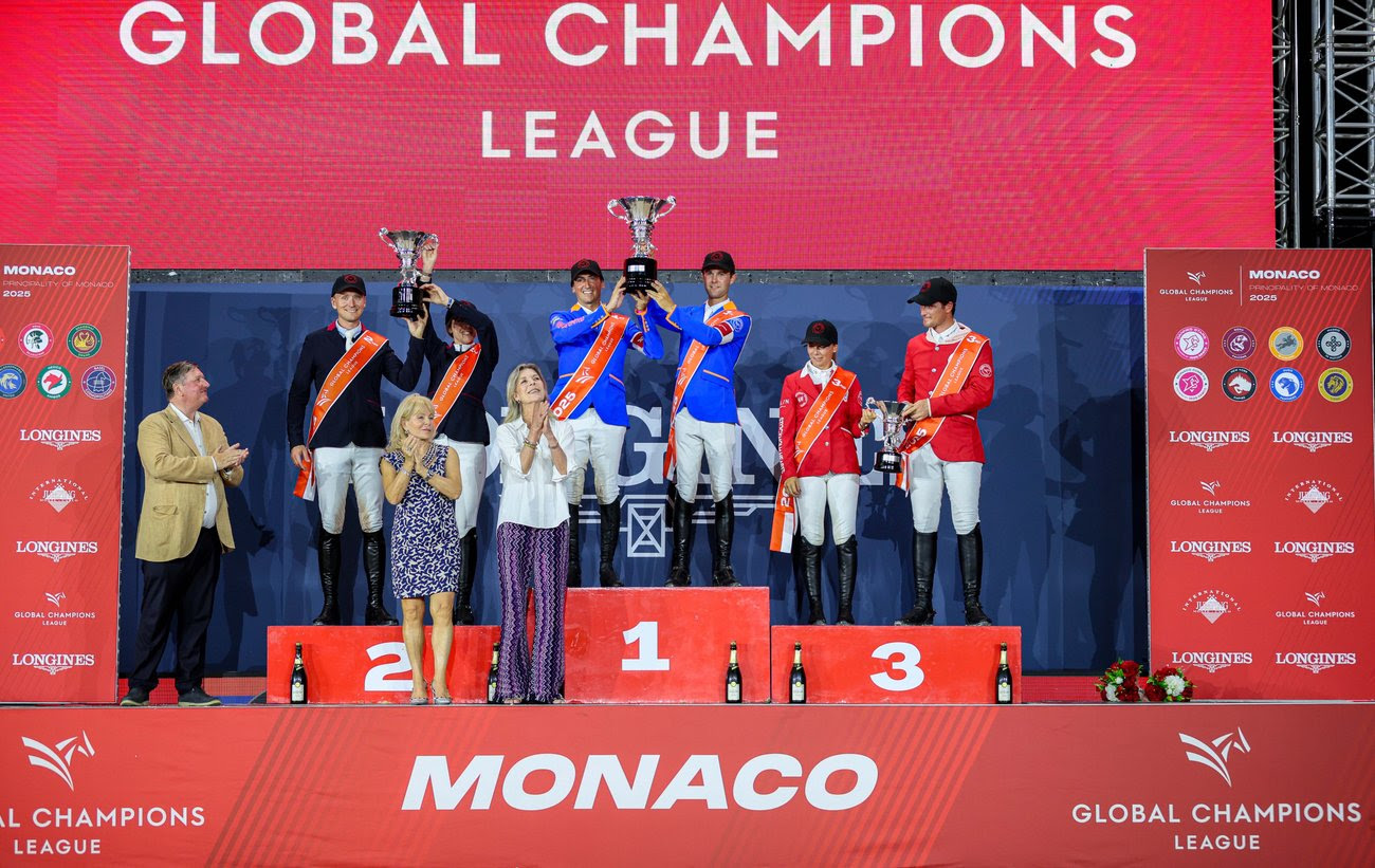 Valkenswaard United riders celebrating their GCL Monaco victory with the Monaco harbour and packed grandstands in the background.