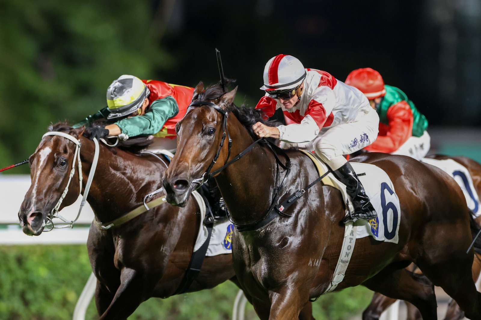 Zac Purton celebrates one of his four victories at Sha Tin Racecourse on July 5, 2025, with a triumphant gesture as the crowd looks on.