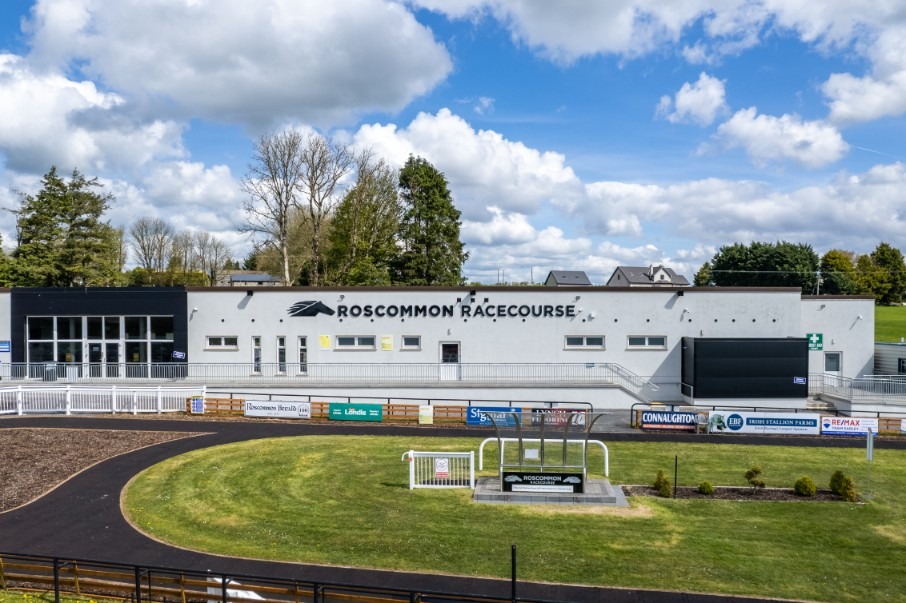 Full field jumps over a hurdle at Roscommon Racecourse during the summer evening card