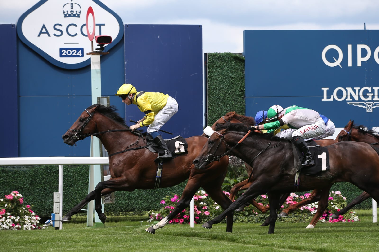 Horses racing at Royal Ascot during the Racing to Zero Summer Mile Weekend as spectators enjoy the vibrant summer event under sunny skies.