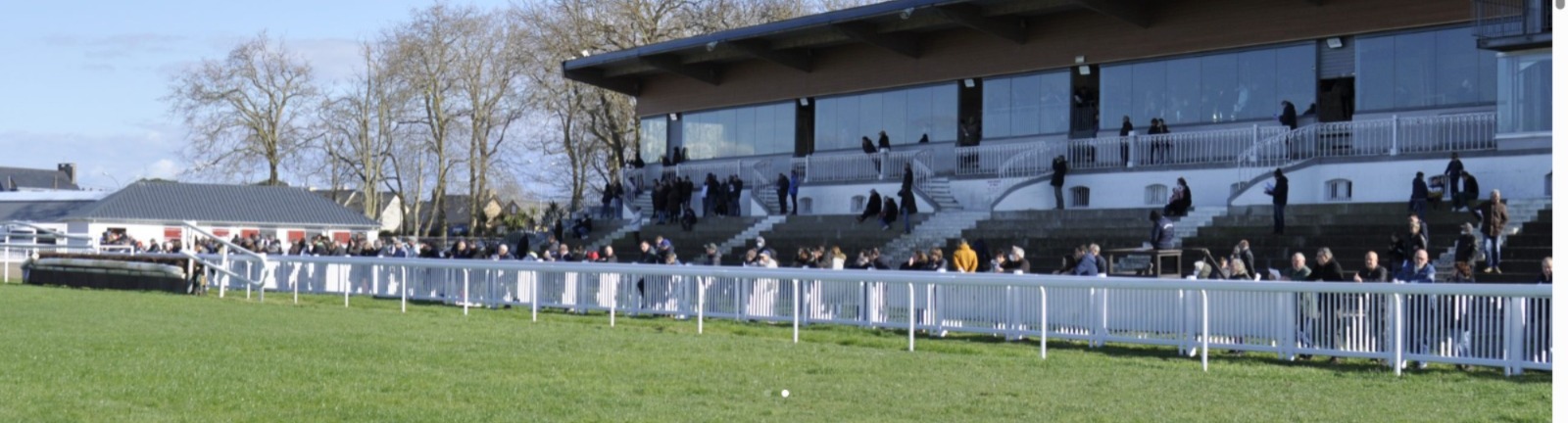 Excited crowd and horses at Saint-Malo Racecourse preparing for the day’s races