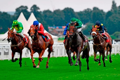 Sandown Park racecourse with spectators enjoying the Group 3 Solario Stakes and 80s celebration