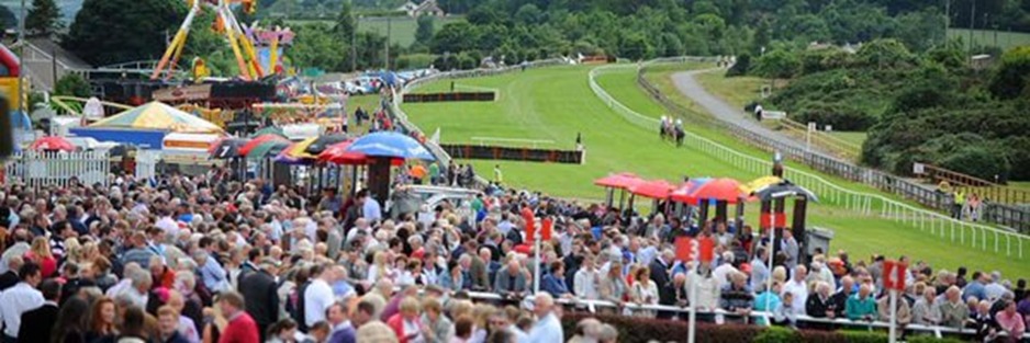 A panoramic view of Bellewstown Racecourse with horses and jockeys preparing for the 27 August 2025 races