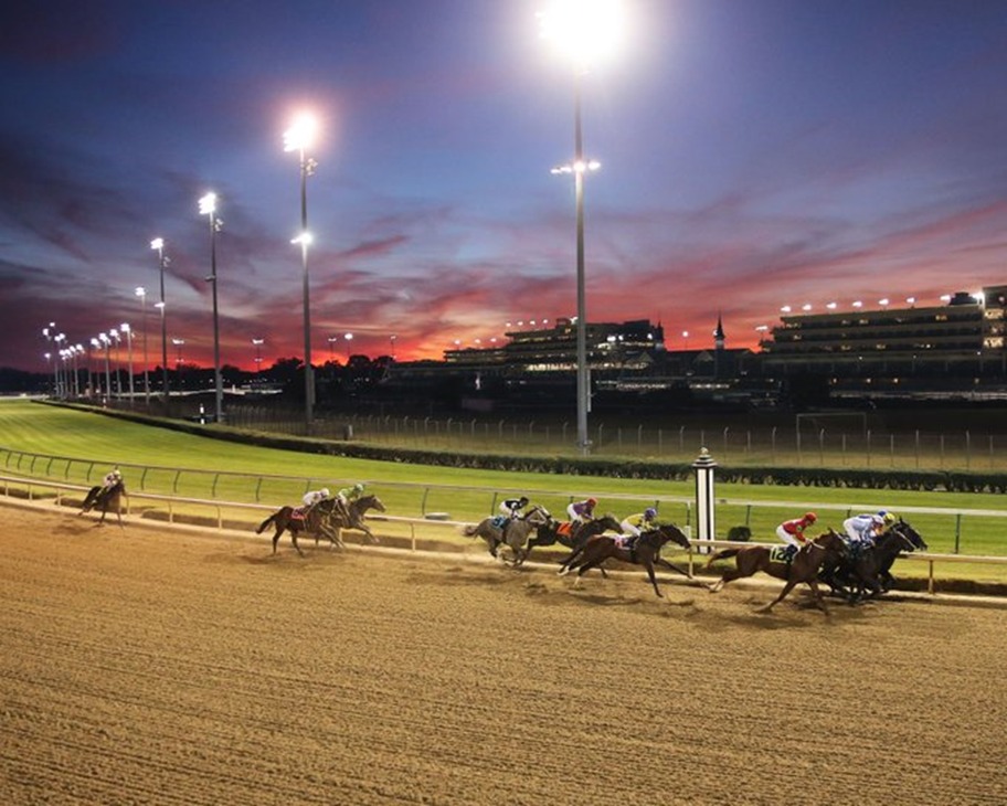 Guests enjoying the Stakes Room Brunch at Churchill Downs with panoramic racetrack views