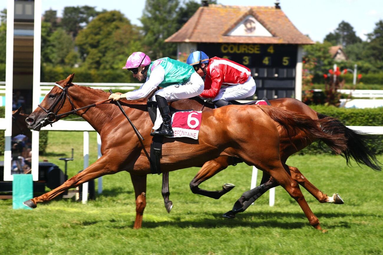 Jockeys and trainers celebrating victories at Chantilly Racecourse on September 1, 2025