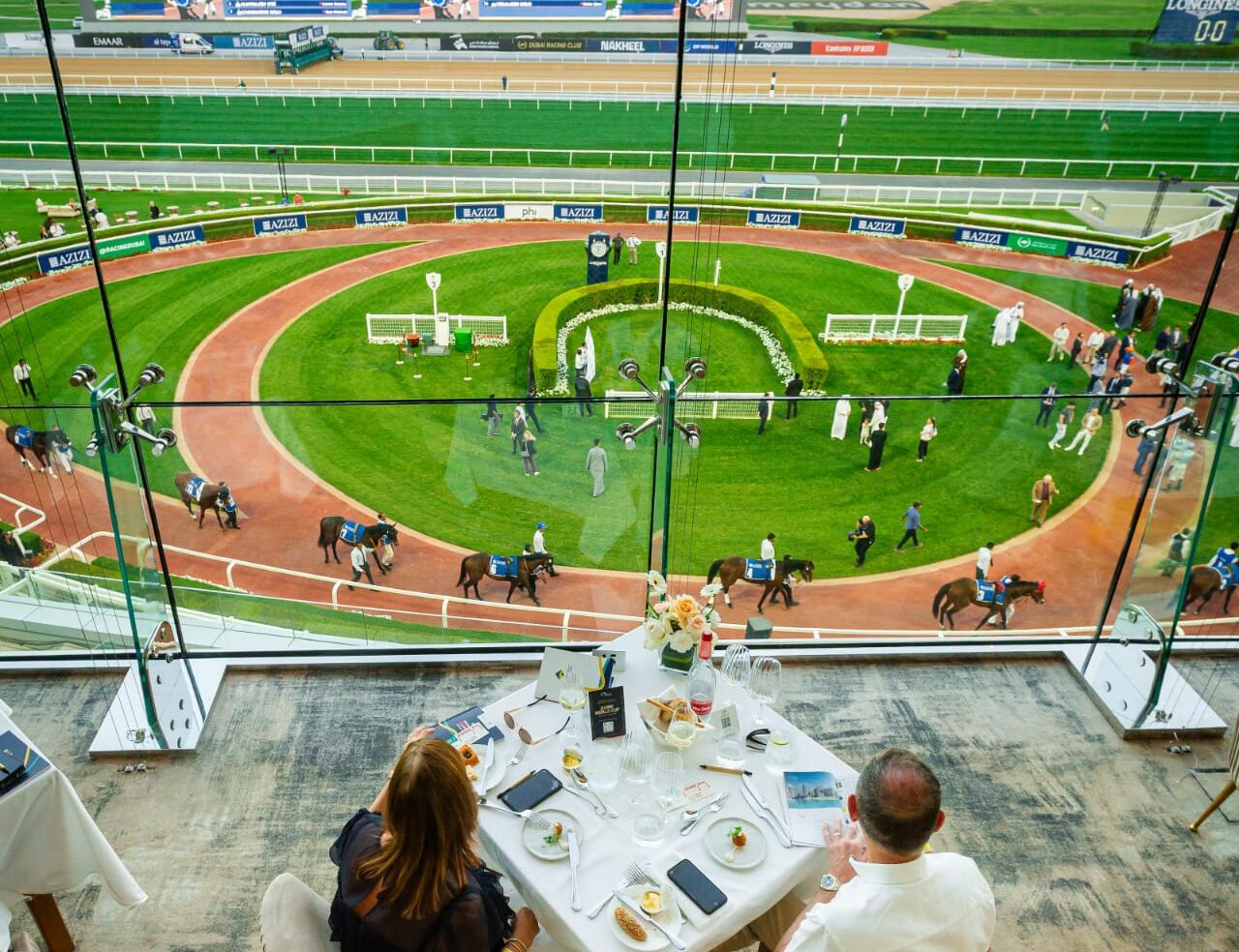 Horses race under the lights at Meydan Racecourse during the opening night of the Dubai Racing Carnival 2025-26.