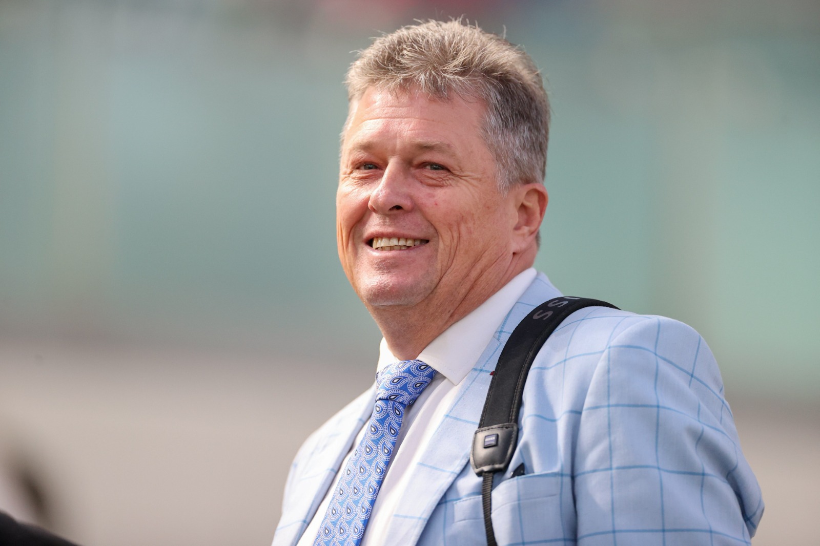Brett Crawford with Conghua-trained horses at Hong Kong racecourse