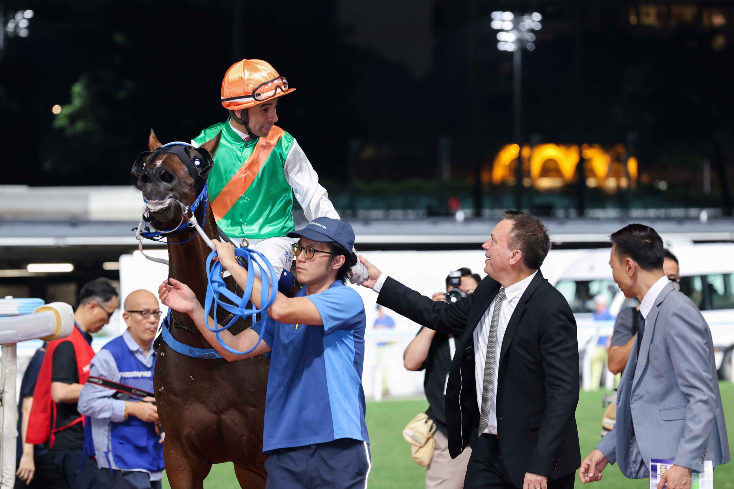 Happy Valley racecourse evening racing action with horses in competition